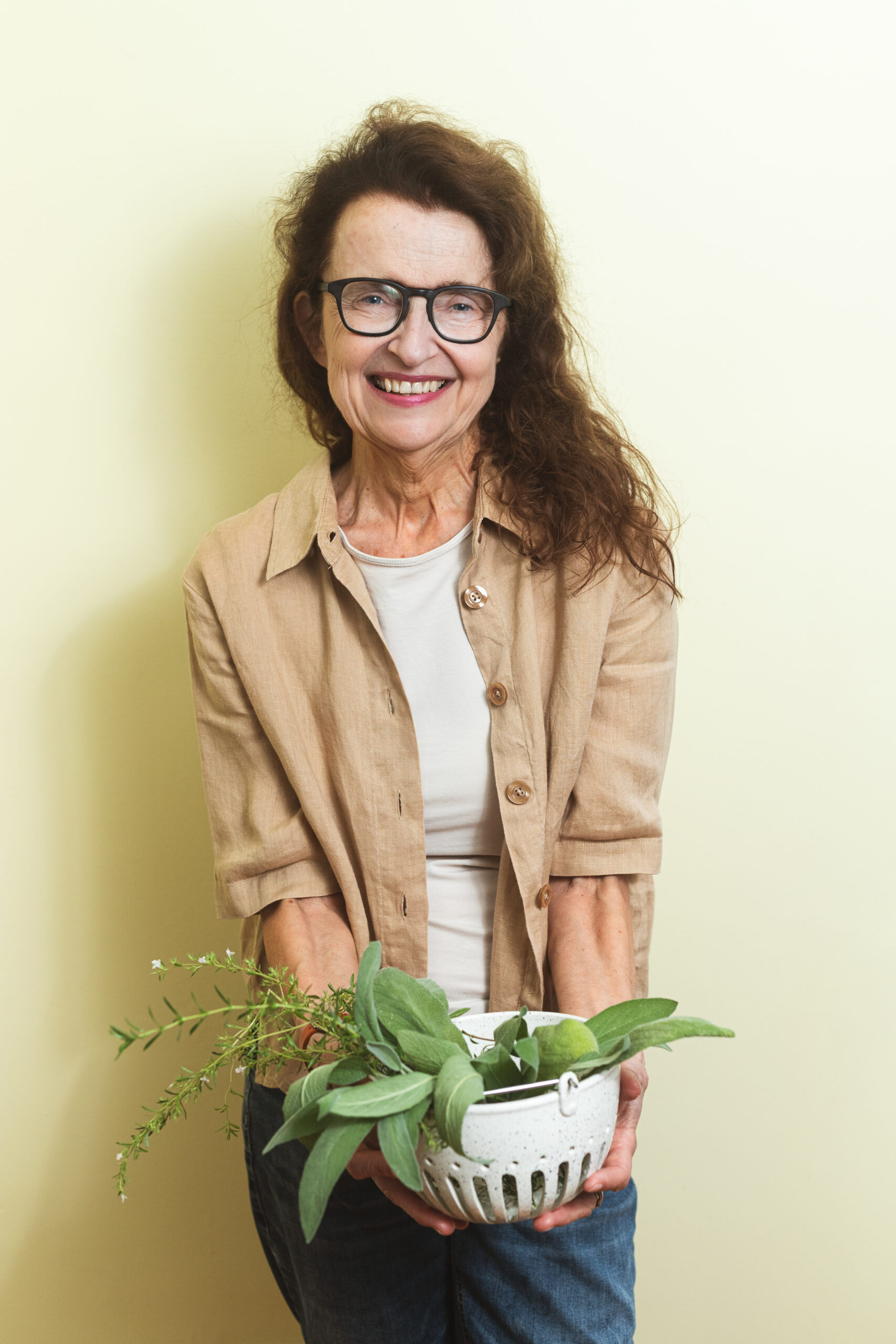 Maria Speck holding fresh herbs